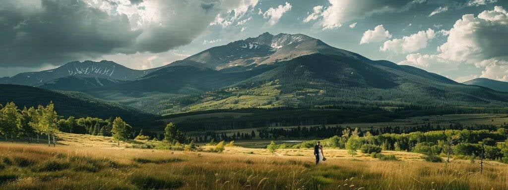 a couple embraces under a majestic colorado mountain backdrop, captured by candid studios' expert wedding photographer.