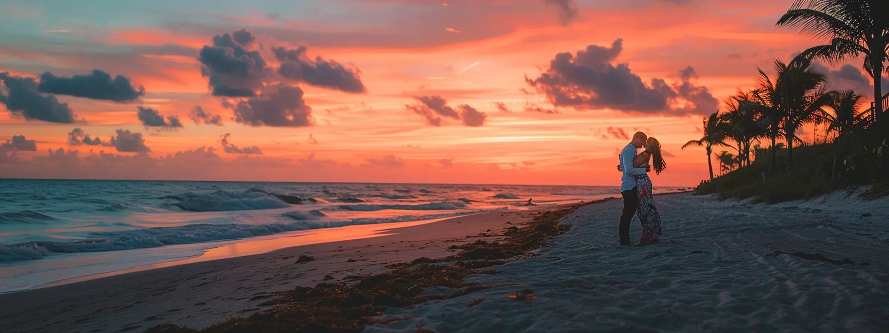 a romantic couple embracing at sunset on a sandy beach with vibrant orange and pink skies in the background for a miami wedding photographer package deal.