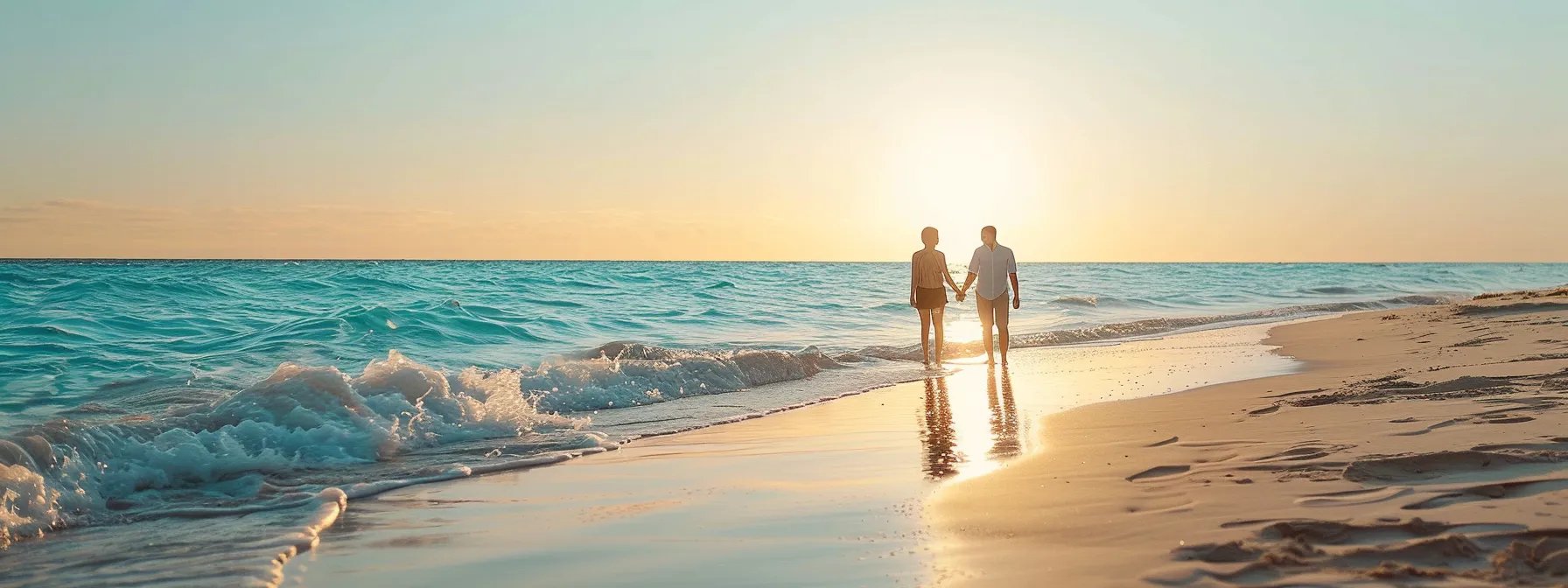 a stunning bride and groom standing on a white sandy beach at sunset, with crystal clear turquoise waves crashing in the background, captured by a talented photographer in miami.
