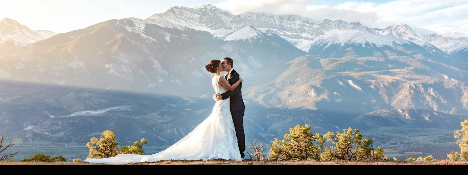 a stunning bride and groom posing in front of a breathtaking mountain backdrop captured by the best grand junction photographer.
